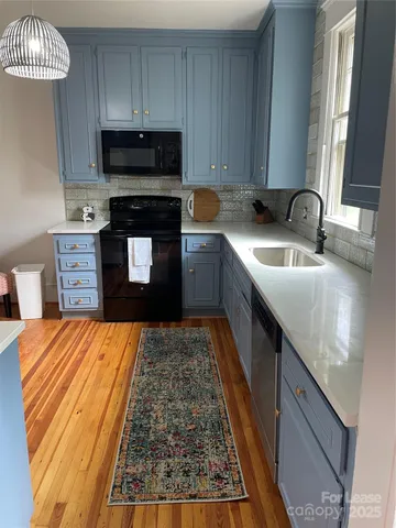 a kitchen with granite countertop a sink and a stove top oven
