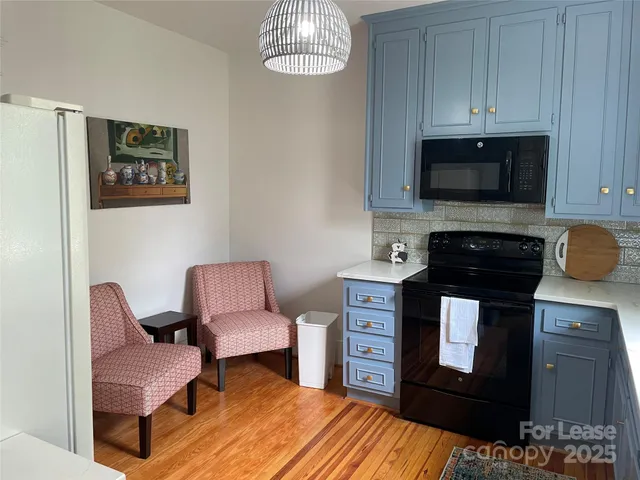 a kitchen with stainless steel appliances a stove a sink and a microwave