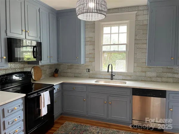 a kitchen with stainless steel appliances a sink stove and cabinets
