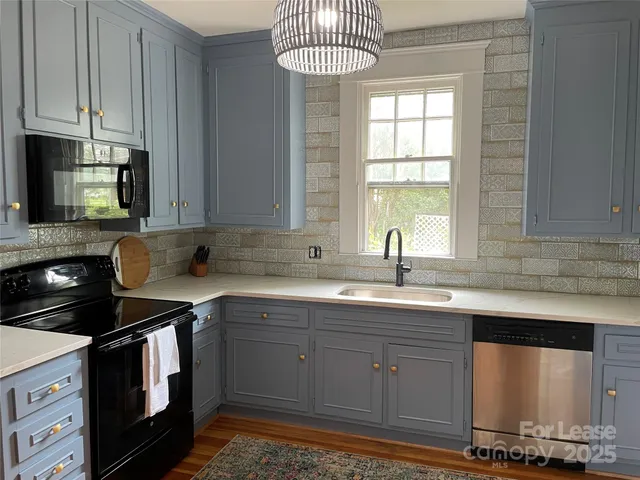 a kitchen with stainless steel appliances a sink stove and cabinets