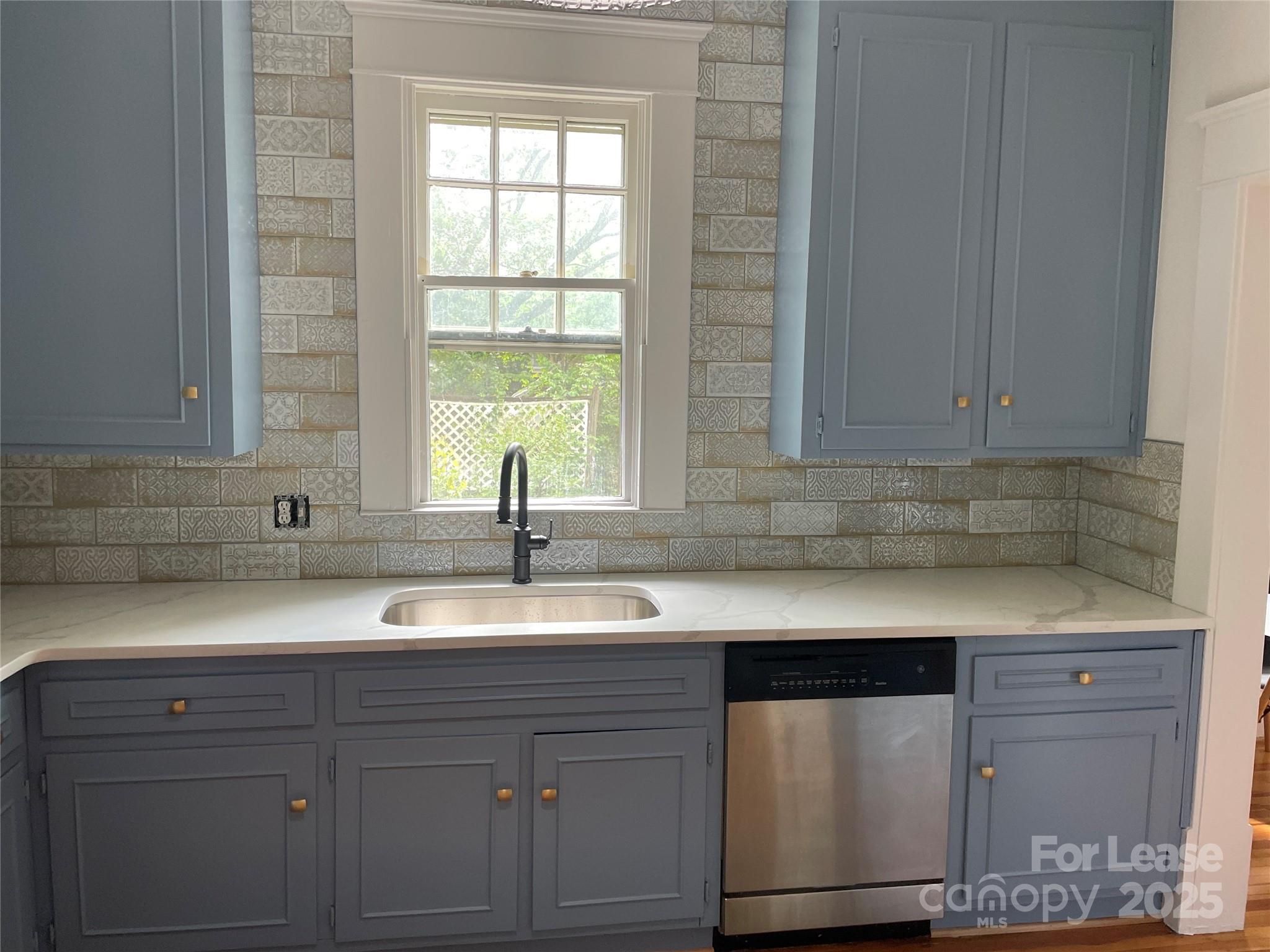 2615 Sharon Road Charlotte, NC 28211 - Photo 9 of 21 a kitchen with granite countertop white cabinets and a sink