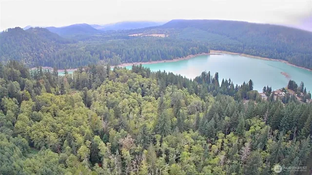 a view of a lush green hillside and a building