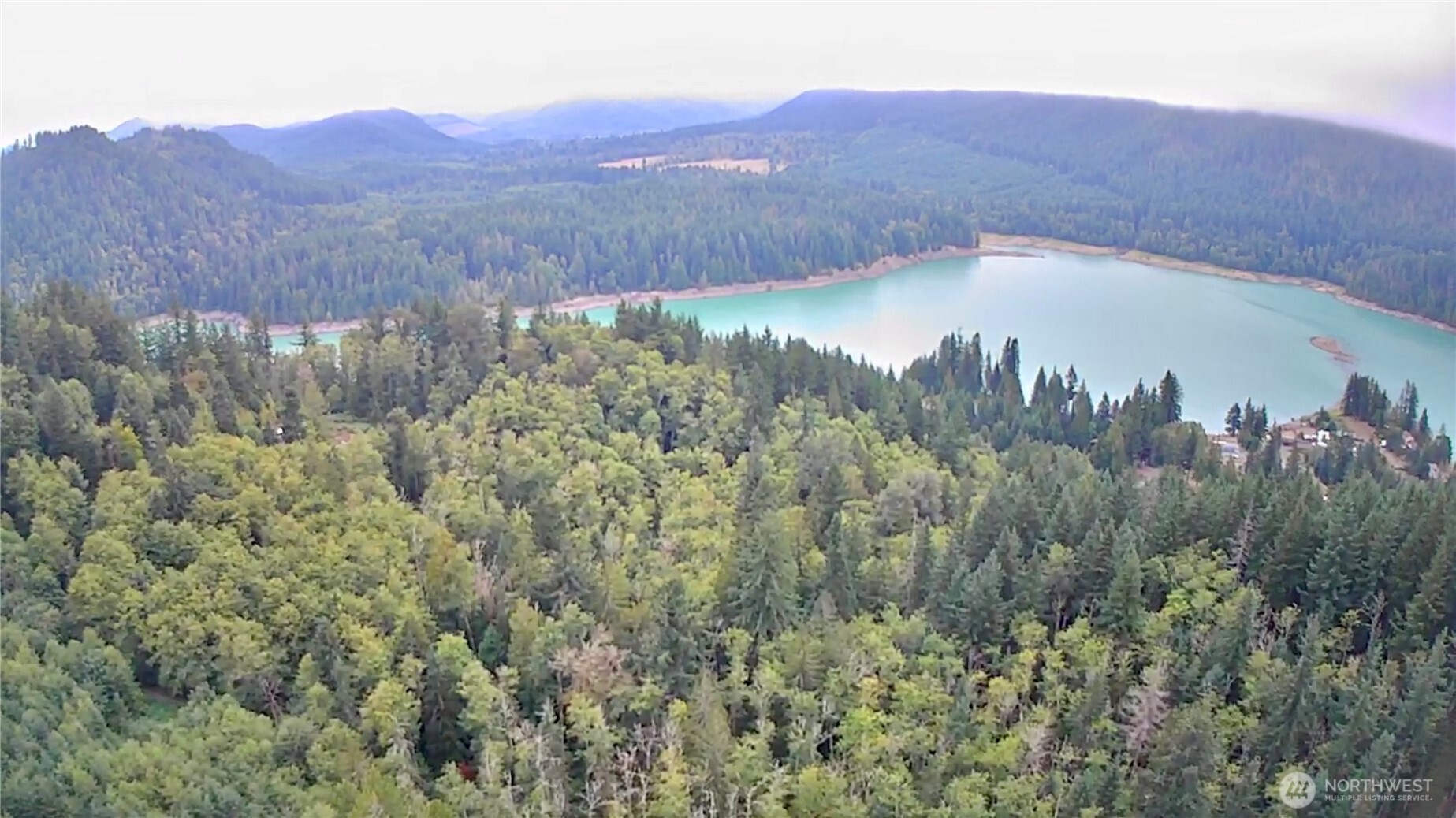 a view of a lush green hillside and a building