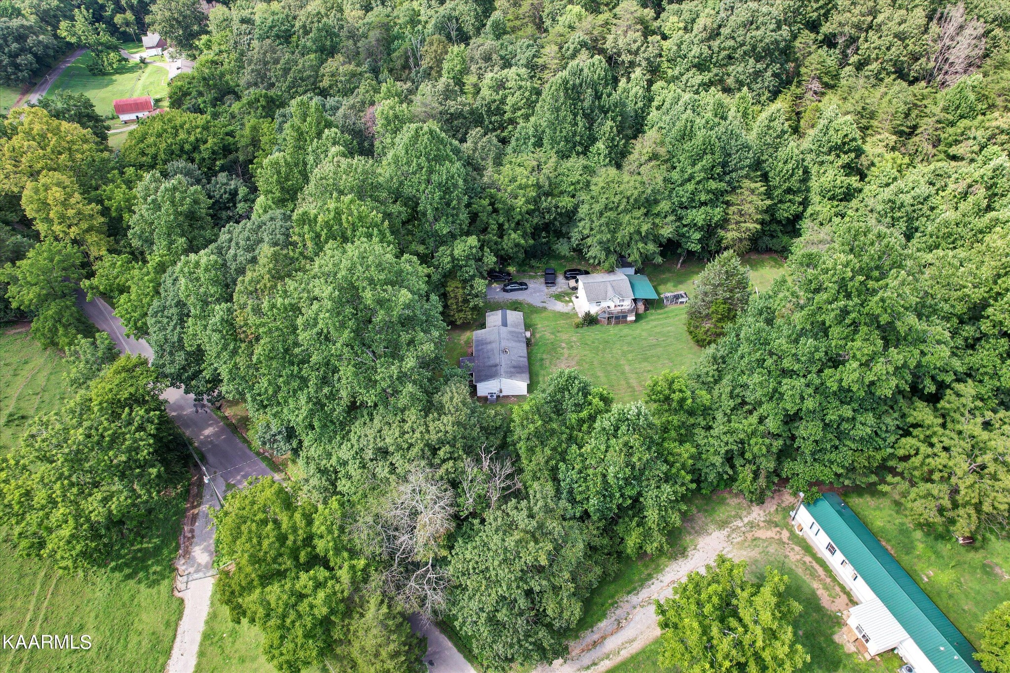 185 Moody Hollow Road Powell, TN 37849 - Photo 31 of 46 a backyard of a house with a yard and outdoor seating