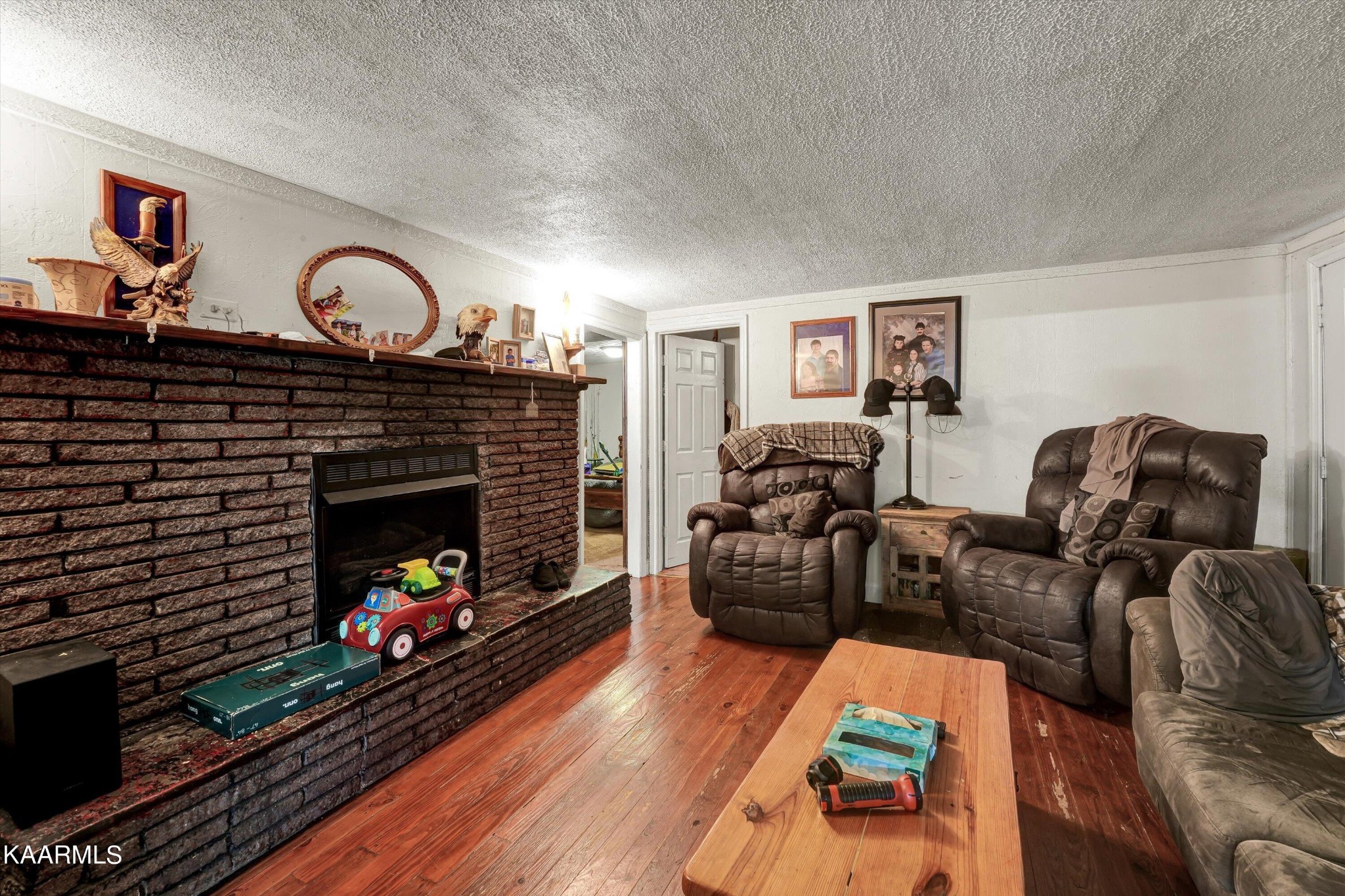 185 Moody Hollow Road Powell, TN 37849 - Photo 4 of 46 a living room with furniture a fireplace and a flat screen tv