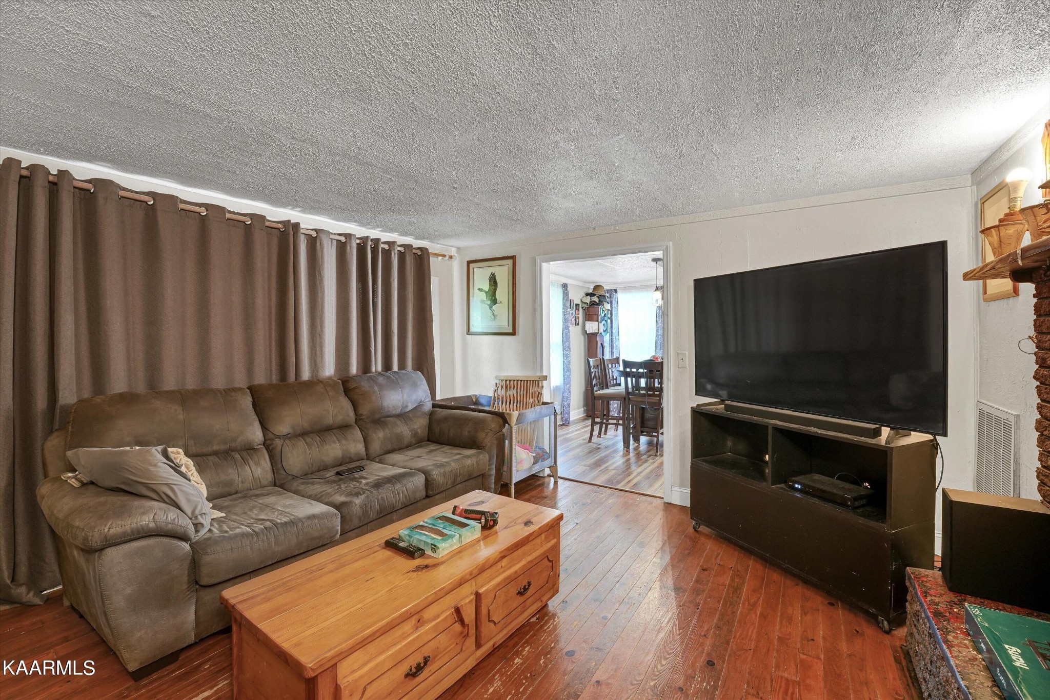 185 Moody Hollow Road Powell, TN 37849 - Photo 6 of 46 a living room with furniture and a flat screen tv