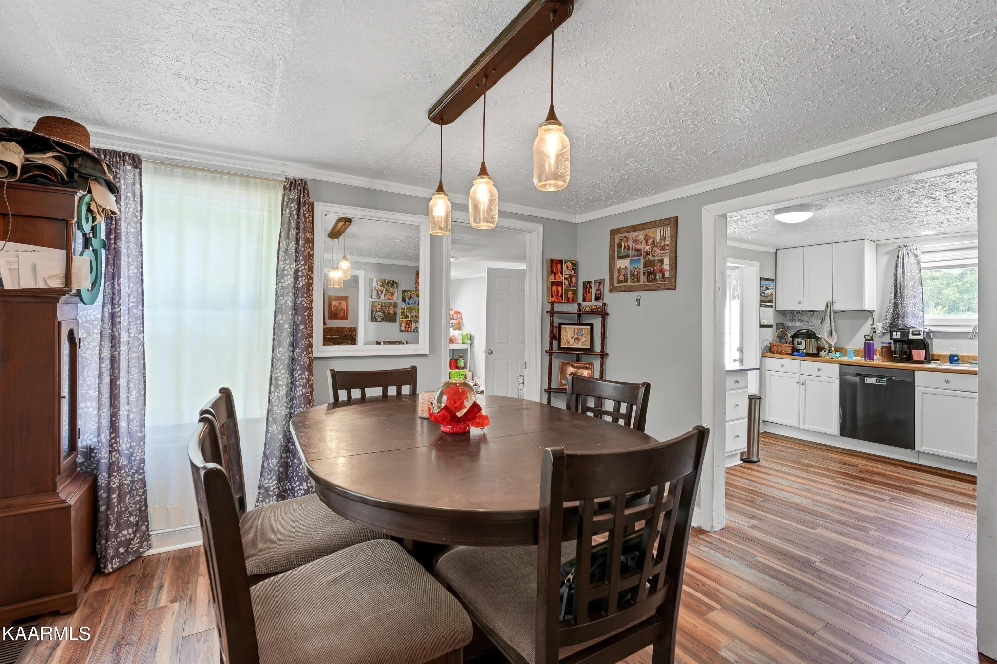 185 Moody Hollow Road Powell, TN 37849 - Photo 7 of 46 a view of a dining room and livingroom with furniture wooden floor a chandelier