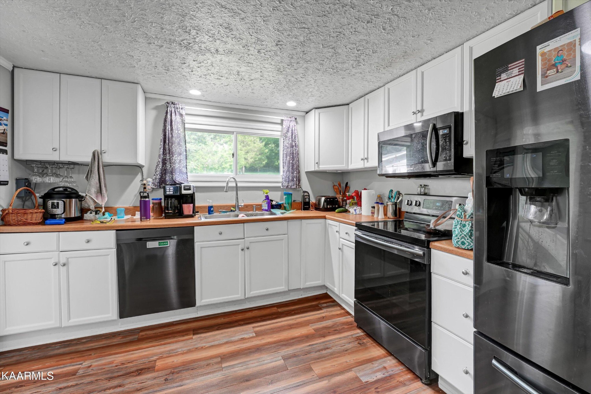 185 Moody Hollow Road Powell, TN 37849 - Photo 9 of 46 a kitchen with stainless steel appliances granite countertop a refrigerator sink and stove