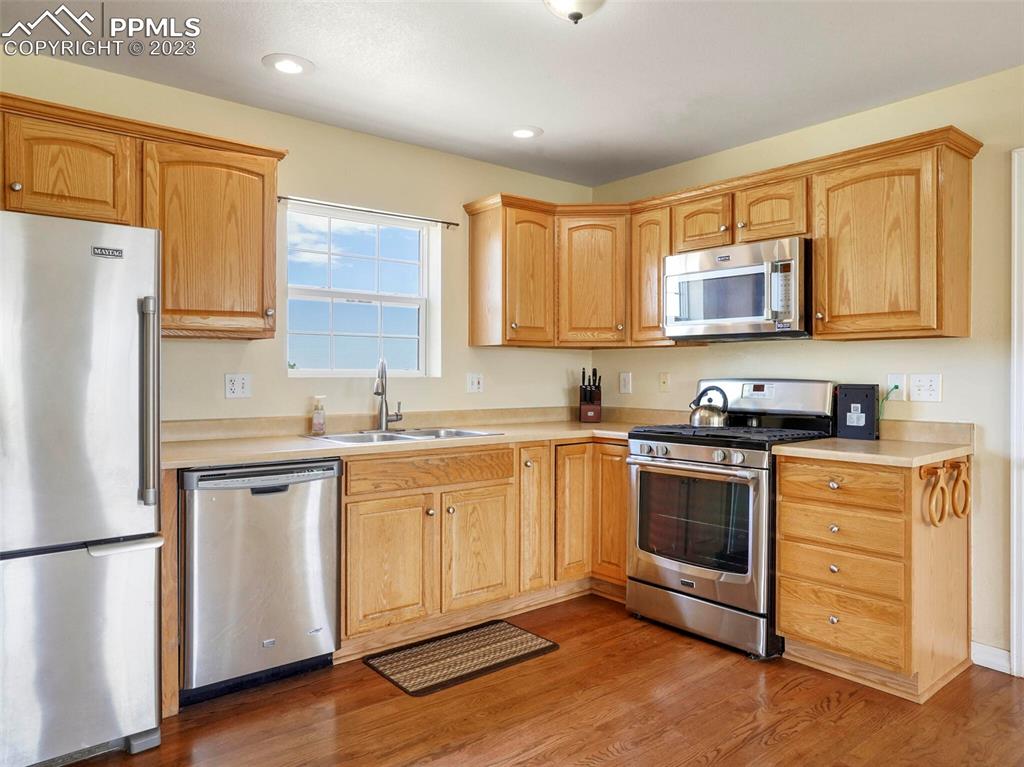 13550 Murphy Road Elbert, CO 80106 - Photo 18 of 42 a kitchen with stainless steel appliances granite countertop a stove a sink and a refrigerator