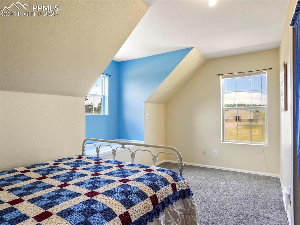 13550 Murphy Road Elbert, CO 80106 - Photo 26 of 42 a bedroom with a bed and a window