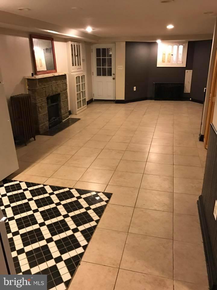 66 Bryant Street Northwest, Unit B Washington, DC 20001 - Photo 3 of 11 a view of a livingroom with wooden floor and a fireplace