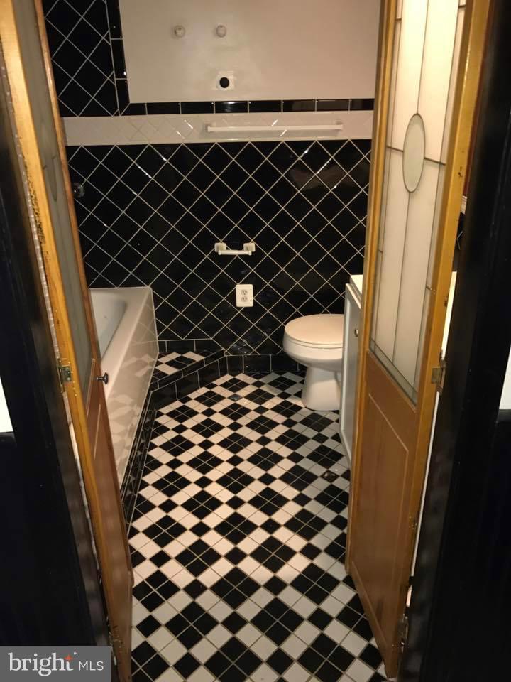 66 Bryant Street Northwest, Unit B Washington, DC 20001 - Photo 8 of 11 a bathroom with a black and white checkered floor