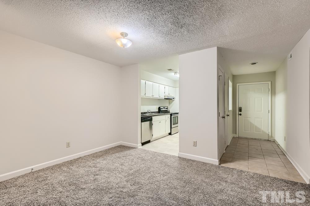 2518 Avent Ferry Road, Unit 103 Raleigh, NC 27606 - Photo 11 of 28 a view of a kitchen with a sink and a refrigerator