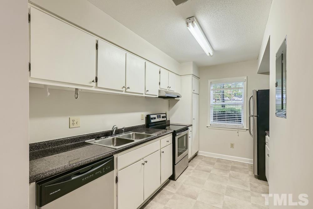 2518 Avent Ferry Road, Unit 103 Raleigh, NC 27606 - Photo 12 of 28 a kitchen with stainless steel appliances granite countertop a sink stove and cabinets