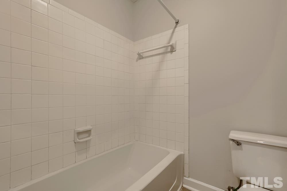 2518 Avent Ferry Road, Unit 103 Raleigh, NC 27606 - Photo 19 of 28 a bathroom with a bathtub and toilet