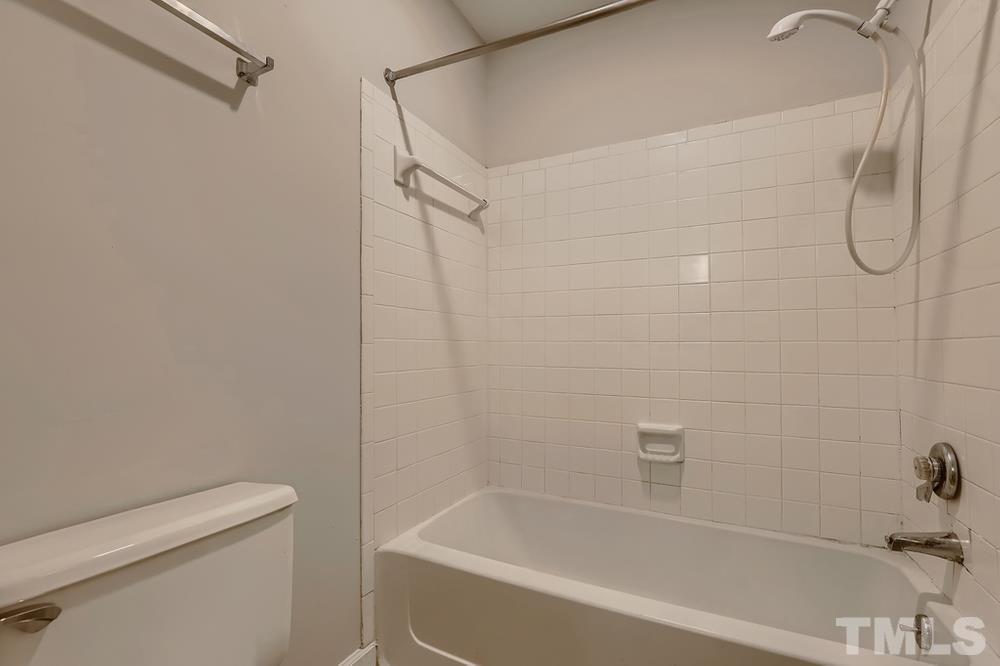 2518 Avent Ferry Road, Unit 103 Raleigh, NC 27606 - Photo 20 of 28 a bathroom with a bath tub and a shower