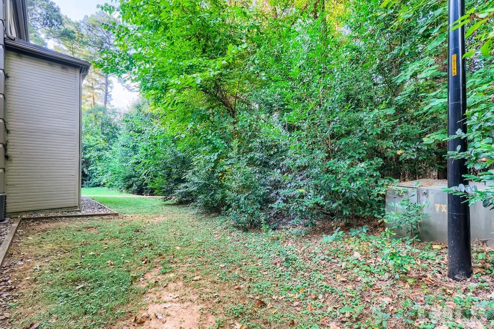 2518 Avent Ferry Road, Unit 103 Raleigh, NC 27606 - Photo 25 of 28 a view of a yard with plants and a large tree