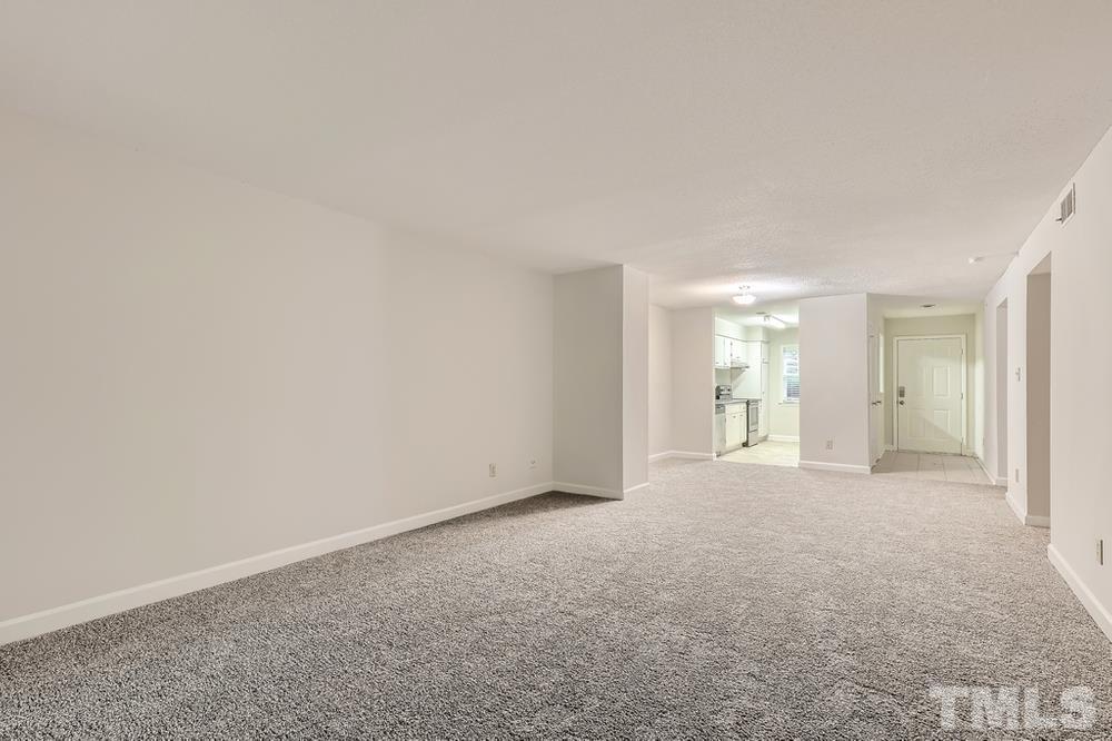 2518 Avent Ferry Road, Unit 103 Raleigh, NC 27606 - Photo 6 of 28 a view of empty room with wooden floor