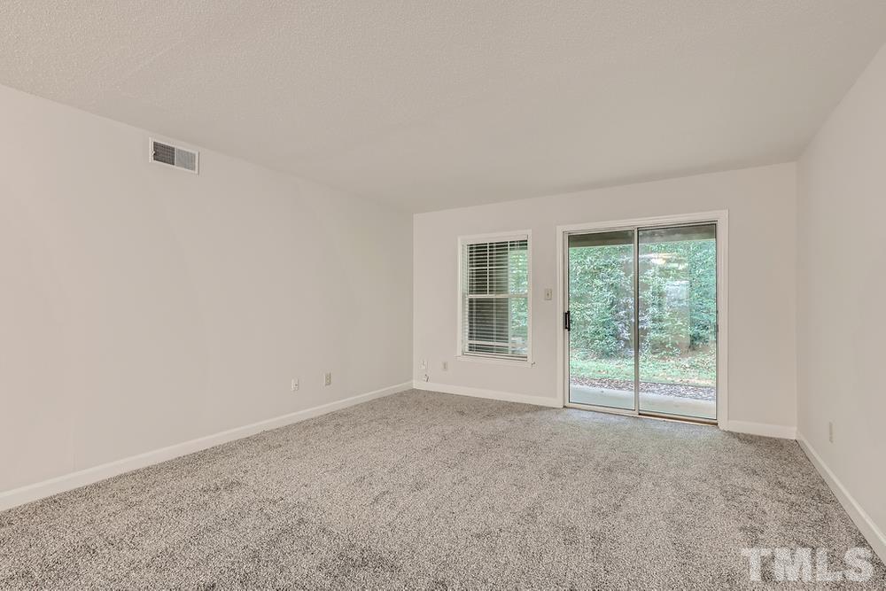2518 Avent Ferry Road, Unit 103 Raleigh, NC 27606 - Photo 8 of 28 a view of an empty room with a window