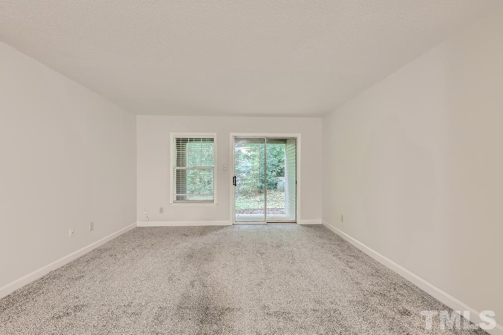 2518 Avent Ferry Road, Unit 103 Raleigh, NC 27606 - Photo 9 of 28 a view of an empty room with a window