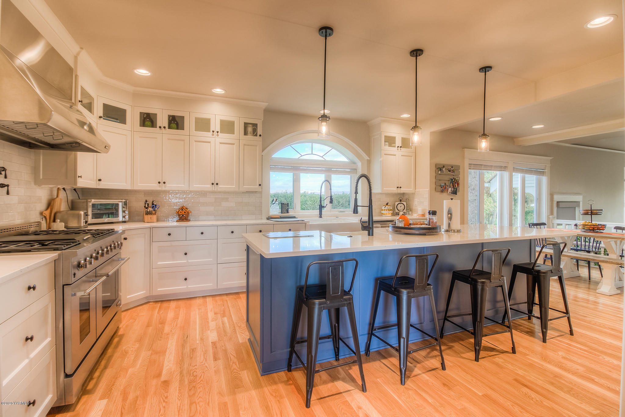 791 Becker Road Toppenish, WA 98948 - Photo 24 of 78 a kitchen with stainless steel appliances granite countertop a stove top oven a sink a dining table and chairs with wooden floor