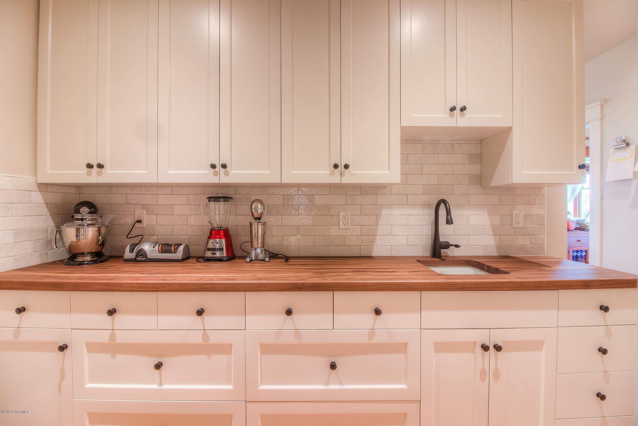 791 Becker Road Toppenish, WA 98948 - Photo 32 of 78 a kitchen with white cabinets and sink