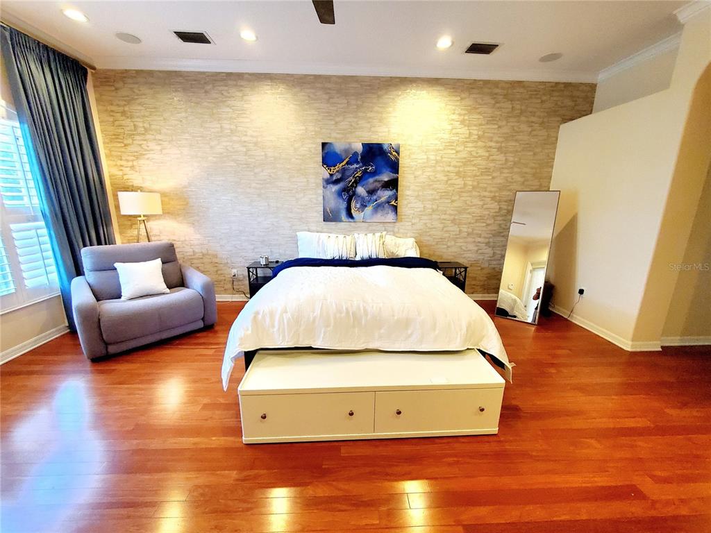 10004 Tree Tops Lake Road Tampa, FL 33626 - Photo 26 of 74 a living room with furniture and a flat screen tv