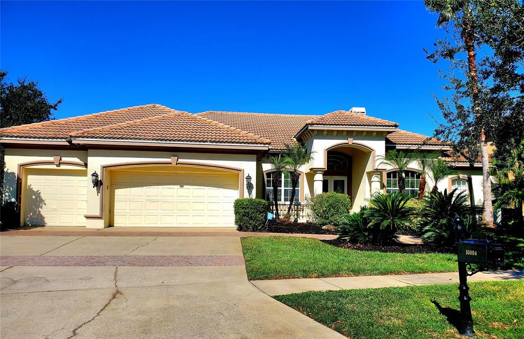 10004 Tree Tops Lake Road Tampa, FL 33626 - Photo 4 of 74 a front view of a house with a yard