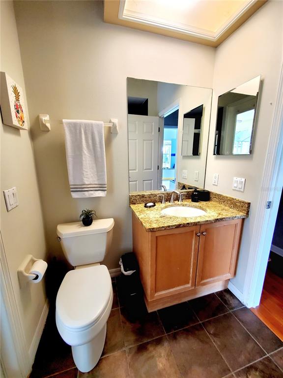 10004 Tree Tops Lake Road Tampa, FL 33626 - Photo 41 of 74 a bathroom with a toilet sink and mirror