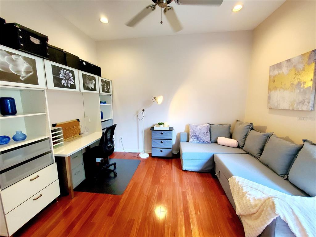 10004 Tree Tops Lake Road Tampa, FL 33626 - Photo 44 of 74 a living room with furniture and a wooden floor