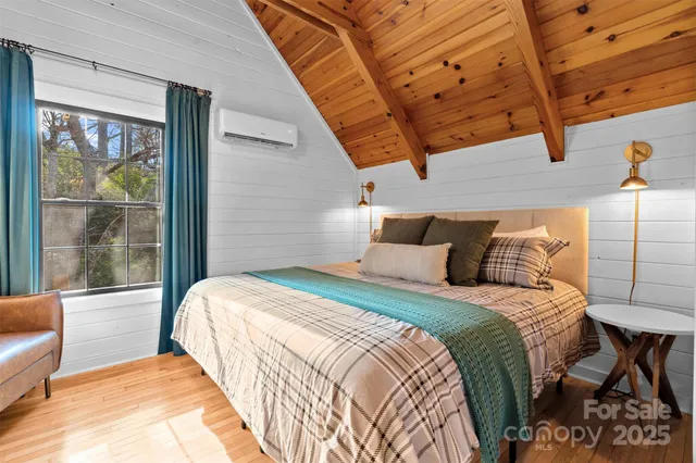 a bedroom with a bed and a large window