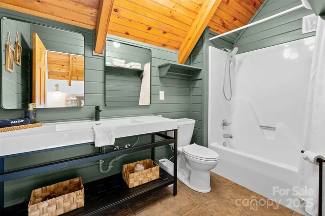 a bathroom with a sink a toilet and a shower