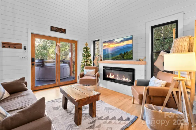 a living room with furniture a flat screen tv and a fireplace