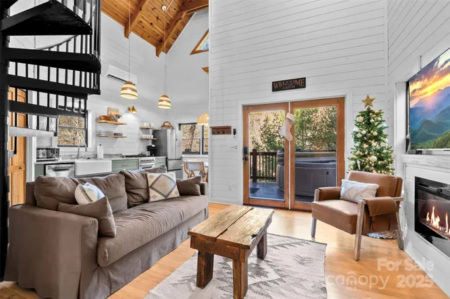 a living room with furniture a flat screen tv and a fireplace