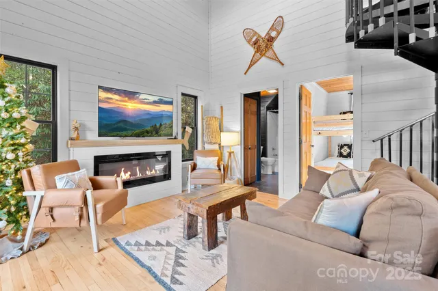 a living room with furniture a rug and a fireplace