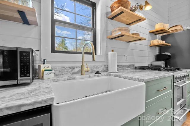 a kitchen with stainless steel appliances granite countertop a sink and a stove
