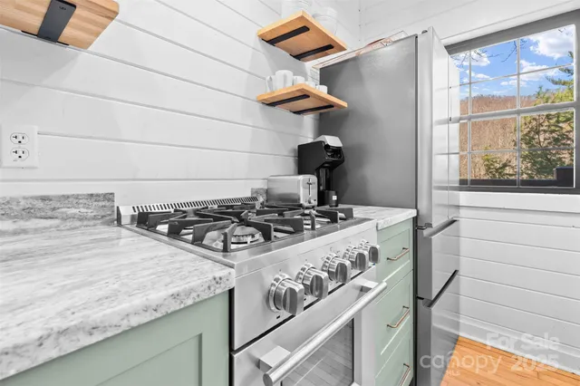 a kitchen with a stove and a window