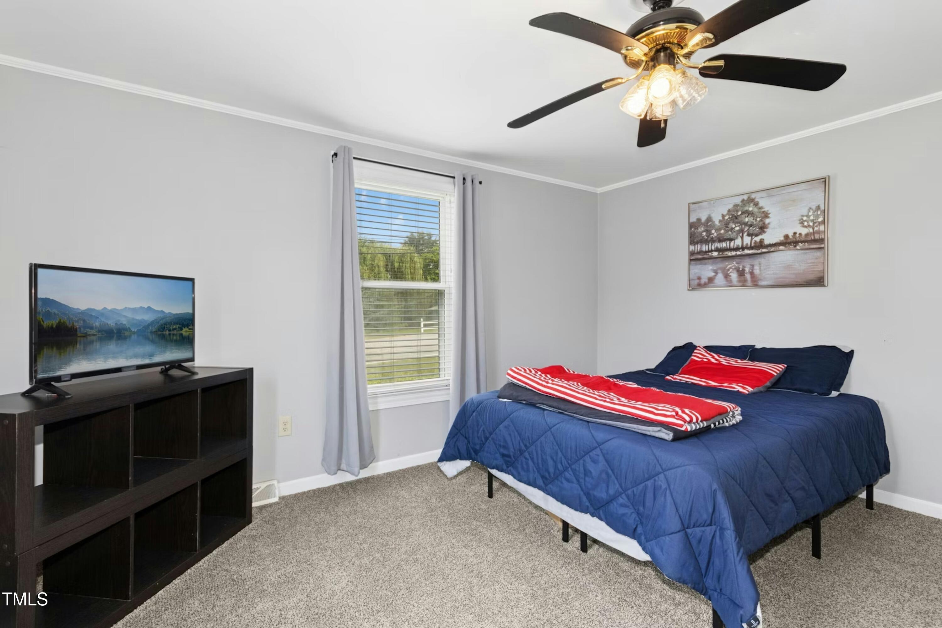 302 North 13th Street Erwin, NC 28339 - Photo 14 of 21 a bedroom with a bed and a flat screen tv