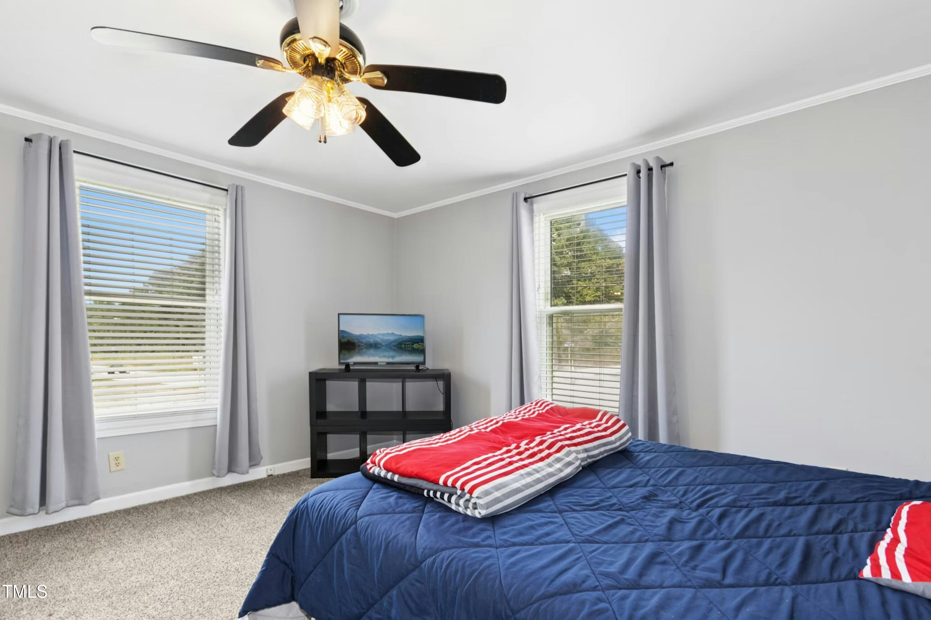 302 North 13th Street Erwin, NC 28339 - Photo 15 of 21 a bedroom with a bed and a window