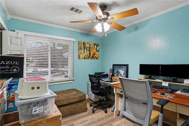 a view of a workspace with furniture and a window