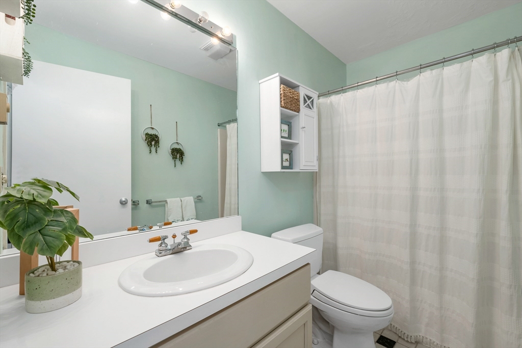 32 Partridge Woods Road, Unit 32 Bartlett, NH 03838 - Photo 23 of 40 a bathroom with a sink toilet and mirror
