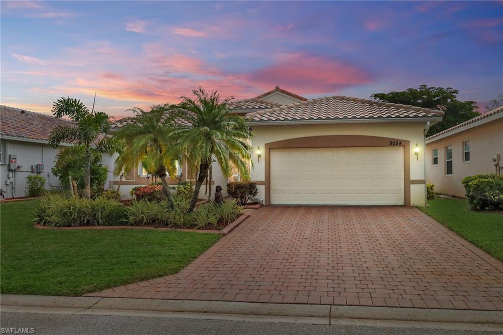 a front view of a house with a yard and garage