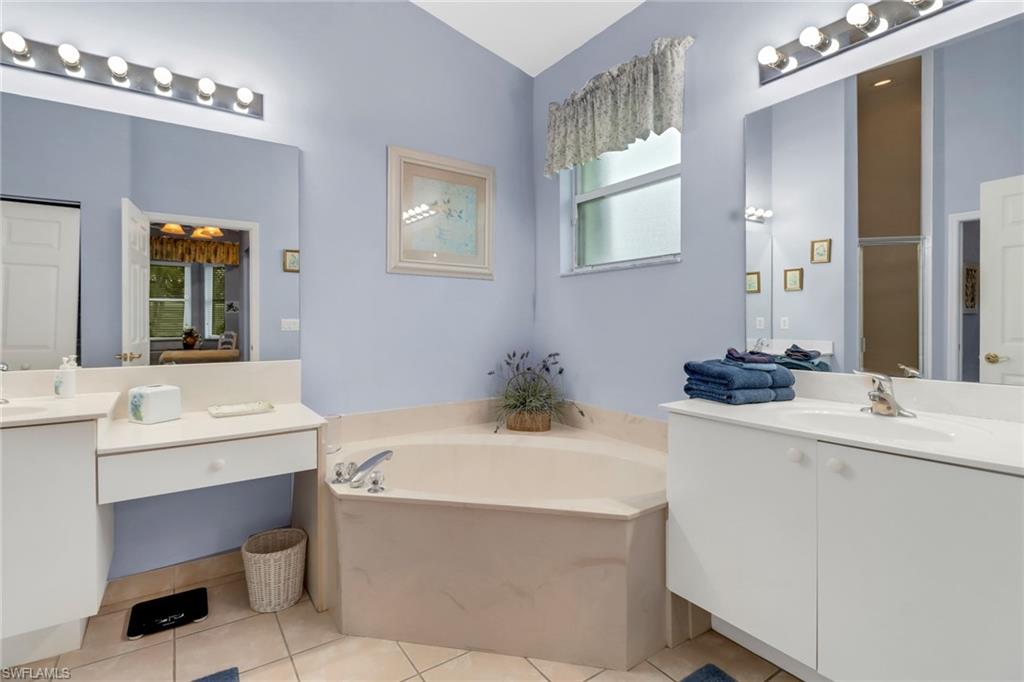 9054 Springview Loop Estero, FL 33928 - Photo 13 of 24 a bathroom with a sink double vanity and a mirror