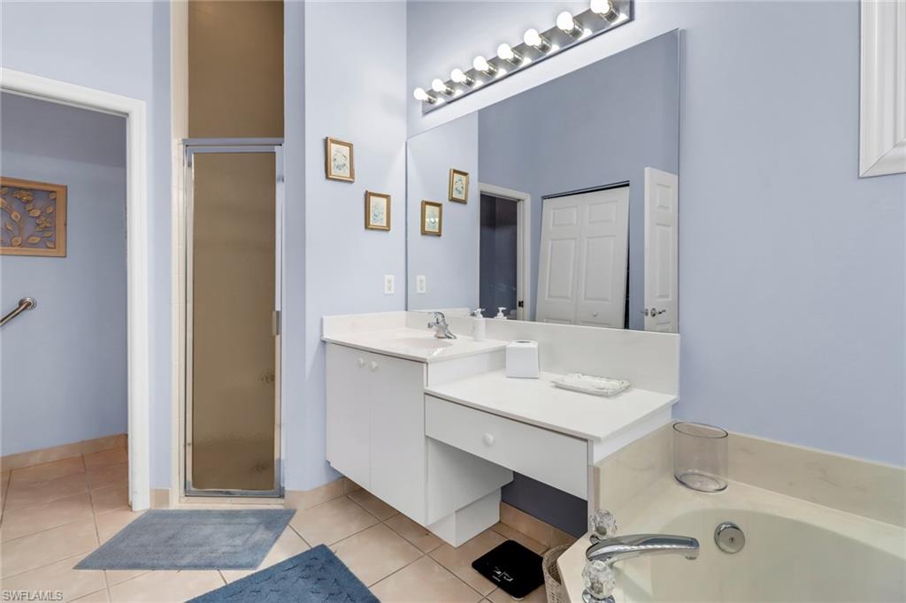 9054 Springview Loop Estero, FL 33928 - Photo 14 of 24 a bathroom with a sink a toilet a mirror and shower