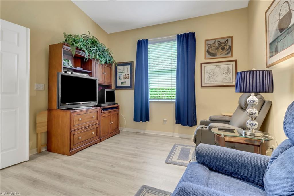 9054 Springview Loop Estero, FL 33928 - Photo 15 of 24 a living room with furniture and a flat screen tv