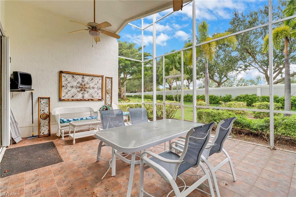 9054 Springview Loop Estero, FL 33928 - Photo 21 of 24 a dining room with furniture and a floor to ceiling window
