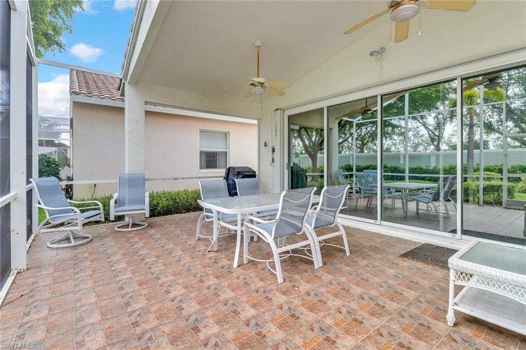 9054 Springview Loop Estero, FL 33928 - Photo 22 of 24 a dining room with furniture and large windows