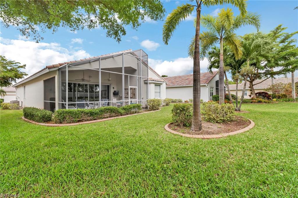 9054 Springview Loop Estero, FL 33928 - Photo 23 of 24 a view of a house with a backyard and a patio