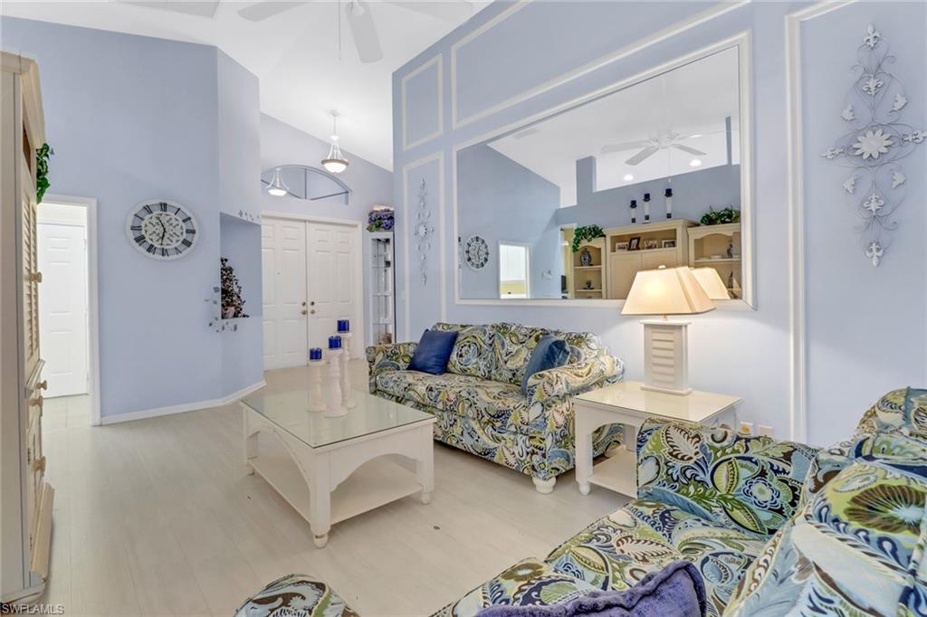 9054 Springview Loop Estero, FL 33928 - Photo 4 of 24 a living room with furniture and a lamp