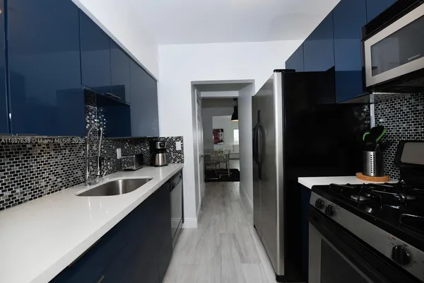 a kitchen with a sink stove and refrigerator